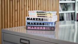 Makers Bible books stacked on a wooden table