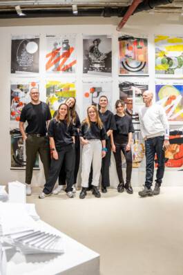 Borrowed Spaces – Melville designers in front of the screen-printed poster wall