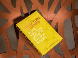 Makers Bible Crafting Cuisine book with yellow cover on a table