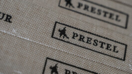 Prestel publishing logo pattern embossed on grey paper