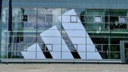 adidas logo on the glass façade of a building at the adidas campus in Herzogenaurach