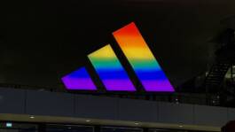 adidas logo illuminated in rainbow light at the adidas campus