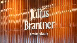 Julius Brantner Brothandwerk bakery sign on a wooden façade in Munich